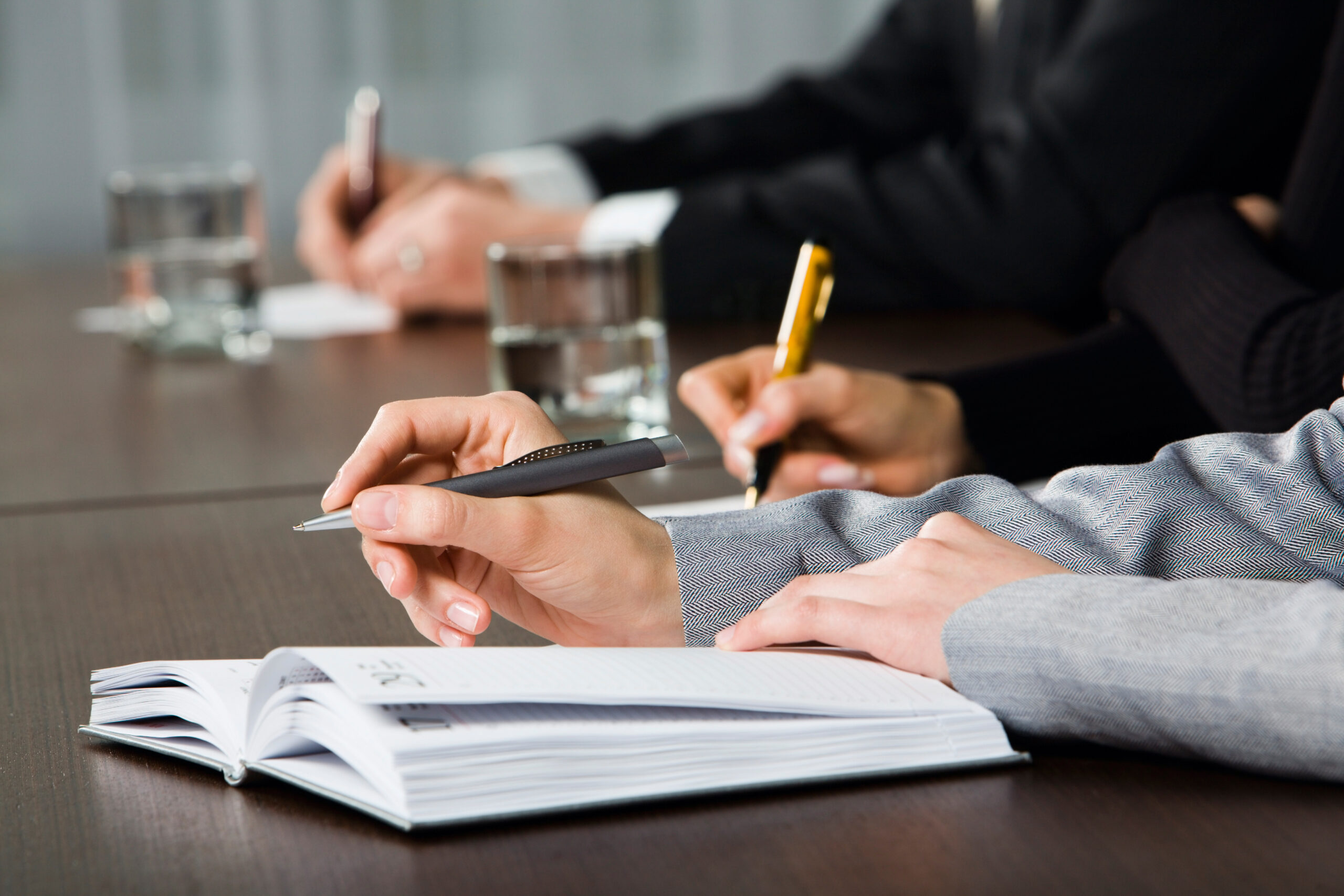 People Writing on Notepads.