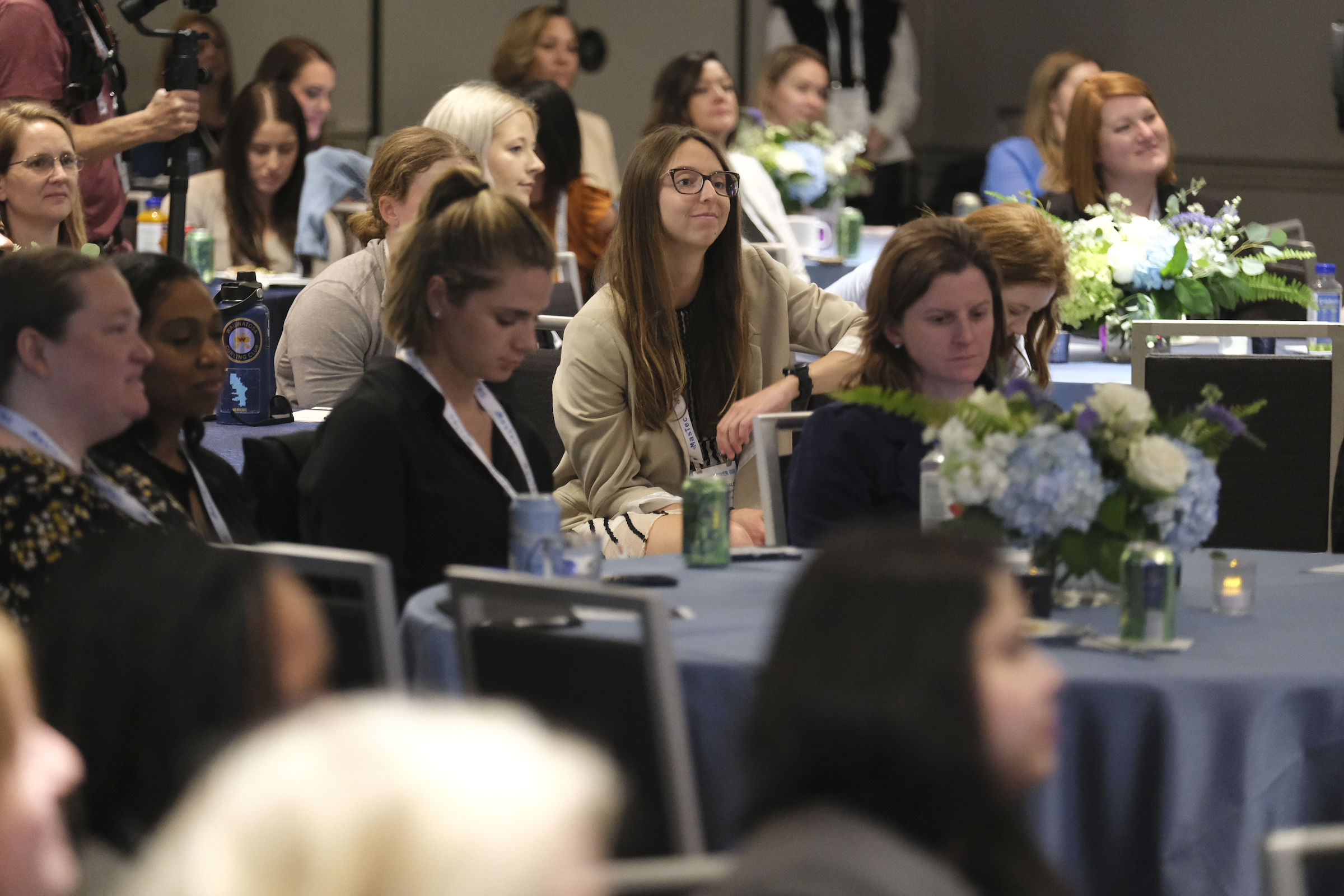 Gorup of women sitting at tables at the EmpowHER Forum