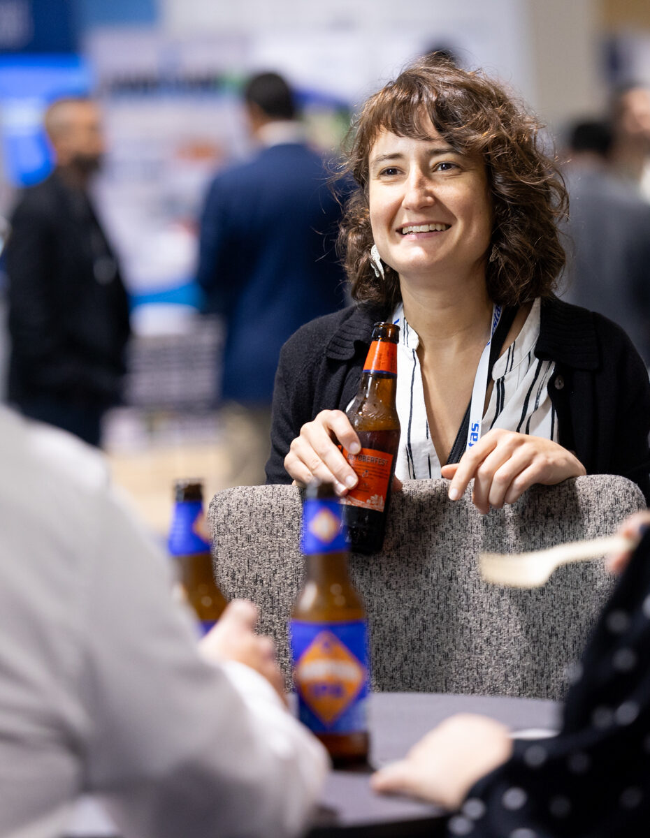 Attendees at an American Clean Power (ACP) Conference networking during a happy hour complete with beer and wine.