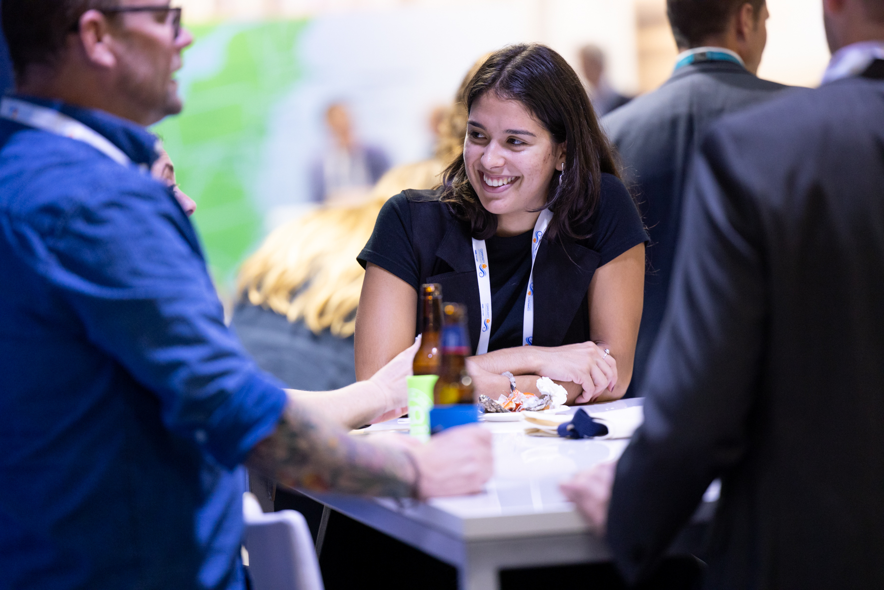 Attendees of an American Clean Power (ACP) conference networking over happy hour beverages.